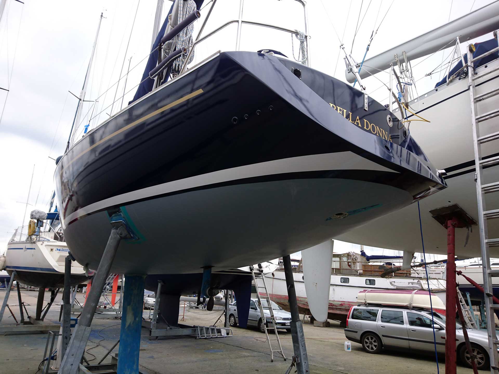 Brand new stripes + boat name have been installed over the top of this freshly wrapped sailing yacht hull.