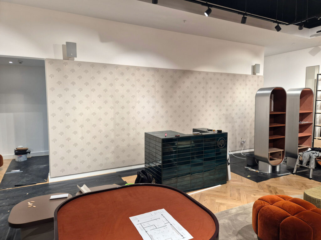 shop interior feature wall wallpaper hanging completed